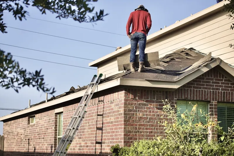 Professional roofer working on a residential roof in Hempstead
